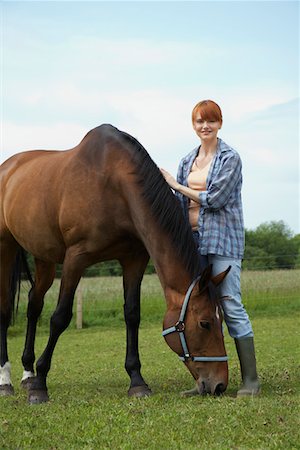 Woman with horse in field, portrait Stock Photo - Premium Royalty-Free, Code: 693-03308403
