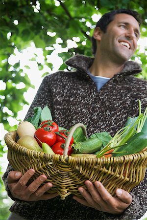 fruits basket low angle - Man holding fruit and vegetable basket, outdoors Stock Photo - Premium Royalty-Free, Code: 693-03308465