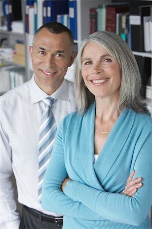 simsearch:693-03305464,k - Business couple standing in office, portrait, elevated view Stock Photo - Premium Royalty-Free, Code: 693-03308845