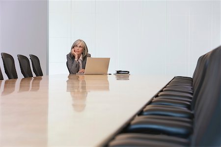 simsearch:693-03305464,k - Business woman sitting by laptop in board room Stock Photo - Premium Royalty-Free, Code: 693-03308866