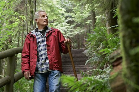 Senior man on trail in forest, looking away Stock Photo - Premium Royalty-Free, Code: 693-03308975