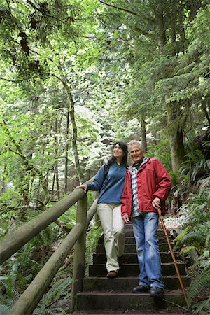 Senior man and middle-aged woman walking on forest trail Stock Photo - Premium Royalty-Free, Code: 693-03308973