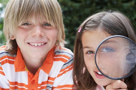 Portrait of boy and girl (7-9) girl holding magnifying glass Stock Photo - Premium Royalty-Free, Code: 693-03309214