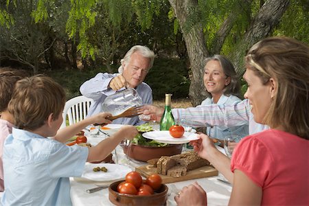 simsearch:400-07048161,k - Three-generation family with children (6-11) dining in garden Stock Photo - Premium Royalty-Free, Code: 693-03309257