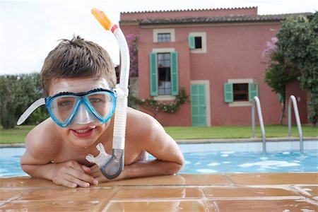 Portrait of boy (10-12) in pool wearing snorkelling mask Stock Photo - Premium Royalty-Free, Code: 693-03309376