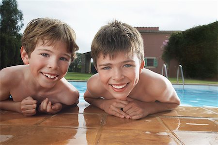 swimming pool leaning on edge - Portrait of two boys (6-11) leaning on edge of pool Stock Photo - Premium Royalty-Free, Code: 693-03309372