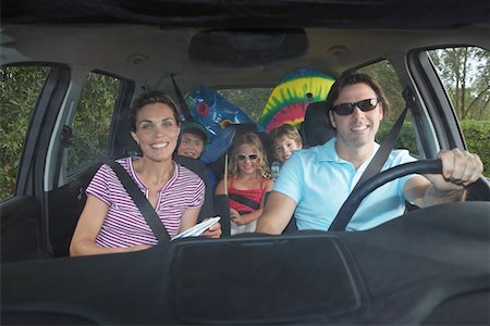 Family with three children (5-11) in car interior, portrait Stock Photo - Premium Royalty-Free, Code: 693-03309404