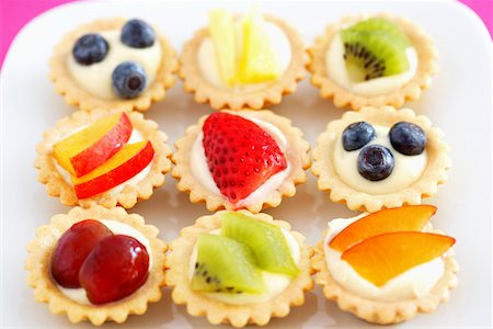 fruit tart - Selection of mini fruit cupcakes, elevated view Stock Photo - Premium Royalty-Free, Code: 693-03309562
