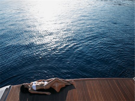 simsearch:693-03313408,k - Woman Sunbathing on Yacht Stock Photo - Premium Royalty-Free, Code: 693-03309735