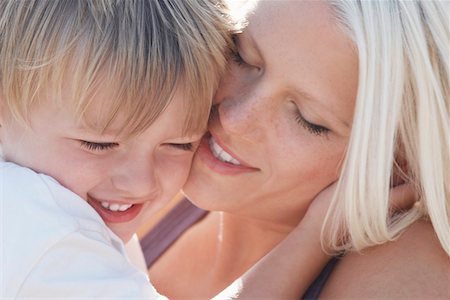 shy child adults - Young mother kissing son (3-4), close-up Stock Photo - Premium Royalty-Free, Code: 693-03309854