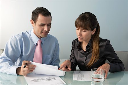 simsearch:693-03707355,k - Business man and woman working at table in office Stock Photo - Premium Royalty-Free, Code: 693-03309886