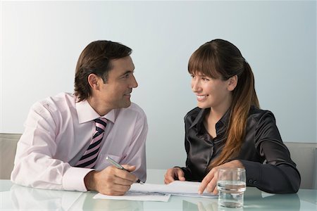 simsearch:693-03707355,k - Business man and woman working at table in office Stock Photo - Premium Royalty-Free, Code: 693-03309888