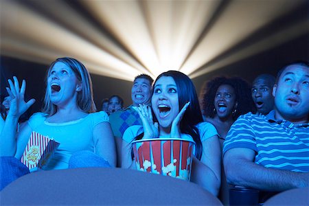 people scared movie theatre - Young People screaming, watching Horror Movie in Theatre Stock Photo - Premium Royalty-Free, Code: 693-03300038