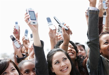 Crowd holding up cell phones, head and shoulders Stock Photo - Premium Royalty-Free, Code: 693-03300075