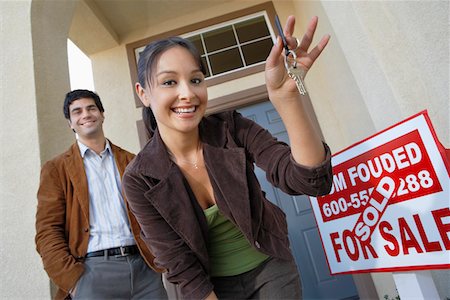 Couple with keys to new home Stock Photo - Premium Royalty-Free, Code: 693-03300122