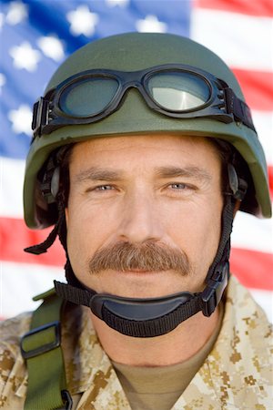 Soldier with moustache in front of United States flag, (close-up), (portrait) Stock Photo - Premium Royalty-Free, Code: 693-03300143