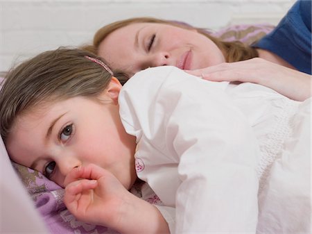 Mother Cuddling With Daughter Stock Photo - Premium Royalty-Free, Code: 693-03300203