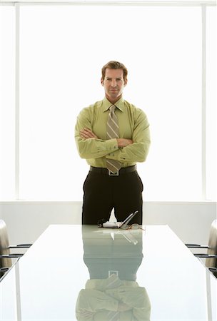 simsearch:693-03564532,k - Businessman with arms crossed at conference table, portrait Stock Photo - Premium Royalty-Free, Code: 693-03300293