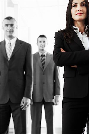 Businesswoman with Businessmen in Background Stock Photo - Premium Royalty-Free, Code: 693-03300669