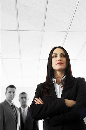 Businesswoman with Businessmen in Background Stock Photo - Premium Royalty-Free, Code: 693-03300670