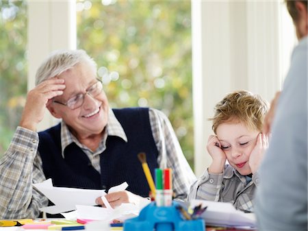 Boy (3-4) laughing with father and grandfather in house Stock Photo - Premium Royalty-Free, Code: 693-03300701