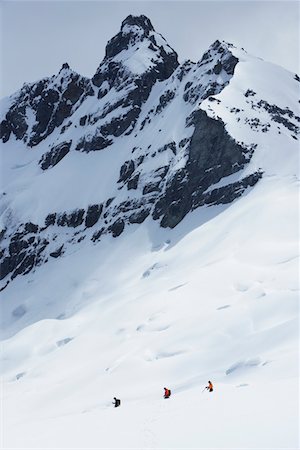 Hikers headed for distant peak in snow, back view Stock Photo - Premium Royalty-Free, Code: 693-03300941
