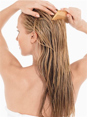 Young Blond Woman Combing wet Hair, back view Stock Photo - Premium Royalty-Free, Code: 693-03301252
