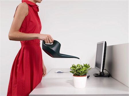 simsearch:693-03301293,k - Female office worker watering desk plant Stock Photo - Premium Royalty-Free, Code: 693-03301306