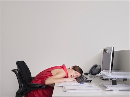 Female office worker asleep at desk in office Stock Photo - Premium Royalty-Free, Code: 693-03301311