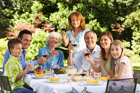 simsearch:649-02731866,k - Family sitting at table for lunch in back yard, portrait Stock Photo - Premium Royalty-Free, Code: 693-03301692