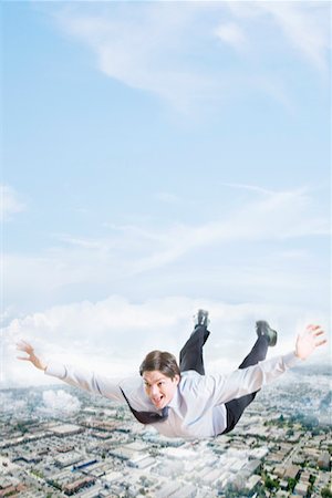 dream businessman - Young businessman flying over city Stock Photo - Premium Royalty-Free, Code: 693-03301880