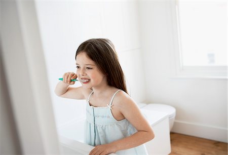 Girl Brushing Teeth in bathroom Stock Photo - Premium Royalty-Free, Code: 693-03301932