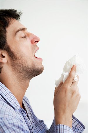 sneeze cold - Man about to sneeze into facial tissue Stock Photo - Premium Royalty-Free, Code: 693-03301941