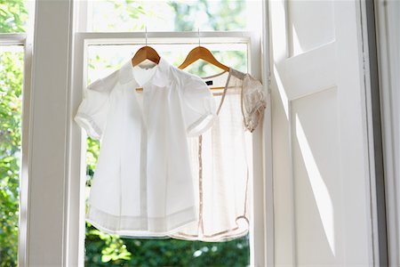 shirt on hanger - Two blouses on Hangers in domestic window Stock Photo - Premium Royalty-Free, Code: 693-03301966