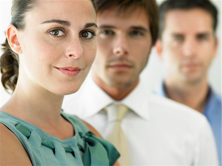 simsearch:693-03564532,k - Businesswoman and two businessmen, focus on woman, portrait Stock Photo - Premium Royalty-Free, Code: 693-03301986