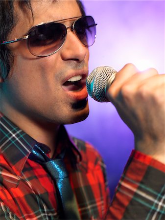 simsearch:693-03302042,k - Young Man Singing into microphone on stage at Concert, close up Stock Photo - Premium Royalty-Free, Code: 693-03302025