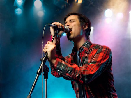 simsearch:693-03302042,k - Young Man Singing into microphone on stage at Concert, low angle view Stock Photo - Premium Royalty-Free, Code: 693-03302023