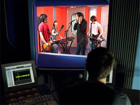 Band in recording studio, technician in foreground Stock Photo - Premium Royalty-Free, Code: 693-03302082
