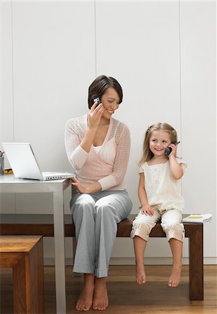 Mother and daughter using cell phones Stock Photo - Premium Royalty-Free, Code: 693-03302338