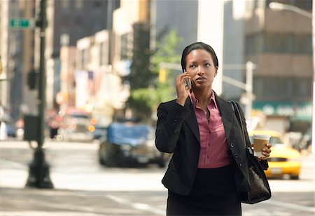 simsearch:693-03564532,k - Businesswoman using mobile phone in street Stock Photo - Premium Royalty-Free, Code: 693-03302404