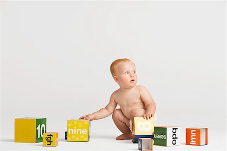 Baby Picking Up Blocks Stock Photo - Premium Royalty-Free, Code: 693-03302587