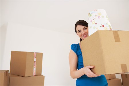 Woman carrying cardboard box Stock Photo - Premium Royalty-Free, Code: 693-03302695