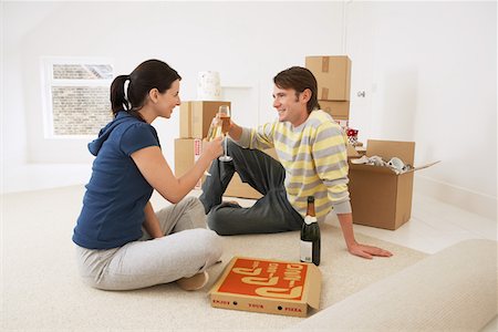 pizza couple - Couple in new home, toasting with champagne and pizza Stock Photo - Premium Royalty-Free, Code: 693-03302693