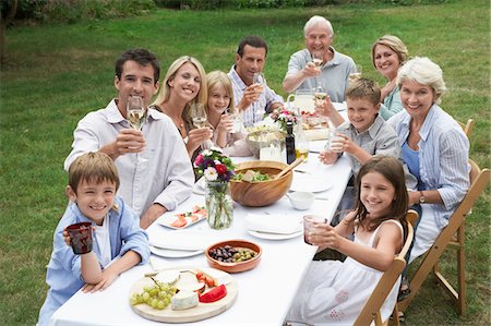 Portrait of three generation family dining in garden Stock Photo - Premium Royalty-Free, Code: 693-03302729