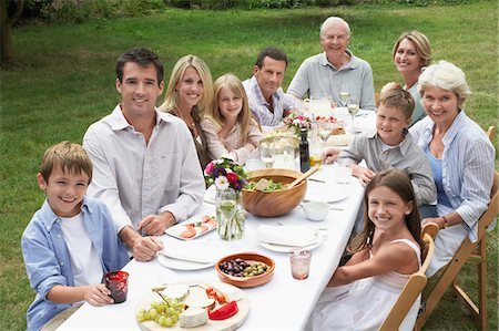 Portrait of three generation family dining in garden Stock Photo - Premium Royalty-Free, Code: 693-03302730