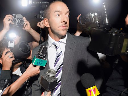scandal - Man surrounded by paparazzi Stock Photo - Premium Royalty-Free, Code: 693-03302756