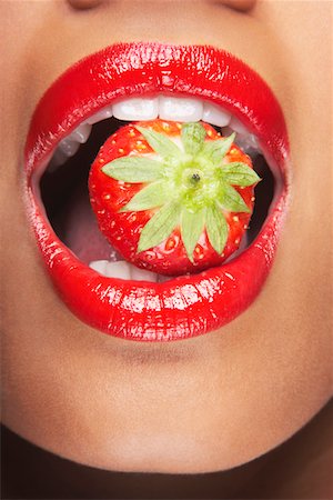 Woman's mouth with strawberry Stock Photo - Premium Royalty-Free, Code: 693-03302803