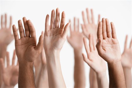Young men and women raising hands, close-up of hands Stock Photo - Premium Royalty-Free, Code: 693-03302887