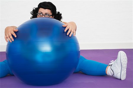 simsearch:693-03557462,k - Uninspired overweight Woman sitting Behind Exercise Ball Stock Photo - Premium Royalty-Free, Code: 693-03302944
