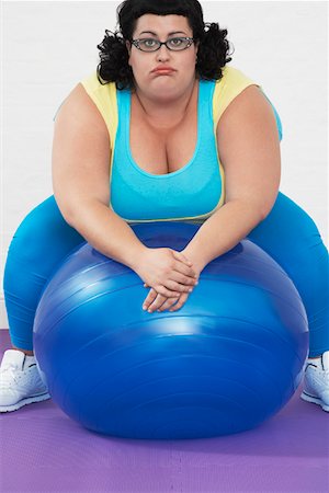 Overweight Woman sitting on Exercise Ball, portrait Stock Photo - Premium Royalty-Free, Code: 693-03302942